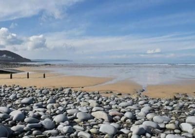 looking across the pebbles to the sand and sea at Westward Ho!